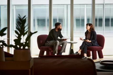 Man and woman having a conversation in an open landscape