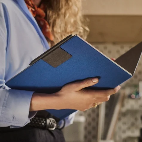 A woman holding a open Book Folio 